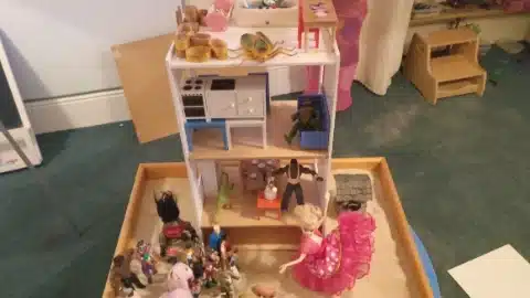 A sandtray featuring Barbie