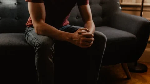Man Sitting On A Sofa